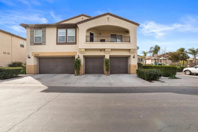 view of front of home with a garage and a balcony