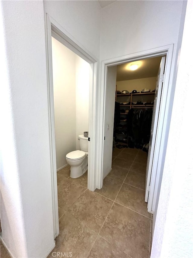 bathroom with tile patterned flooring and toilet