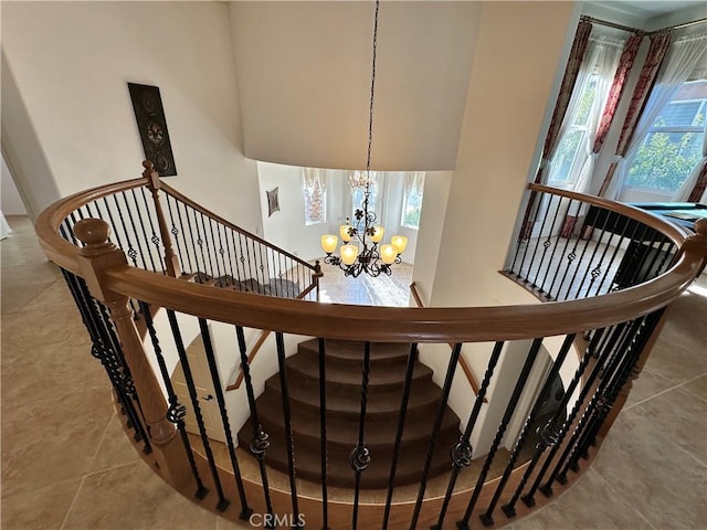 staircase featuring an inviting chandelier