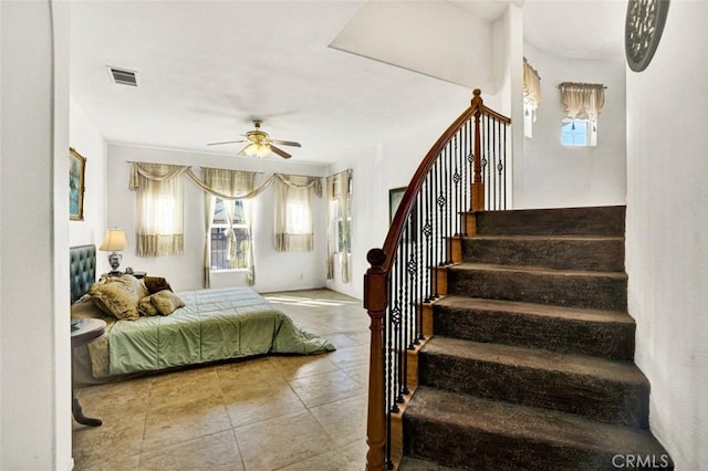 bedroom featuring ceiling fan and tile patterned floors