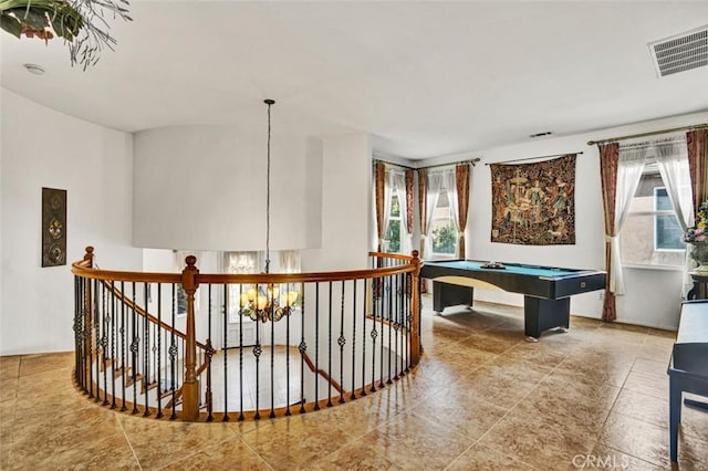 game room with billiards and a chandelier