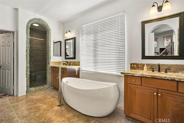 bathroom featuring vanity, tile patterned floors, and independent shower and bath