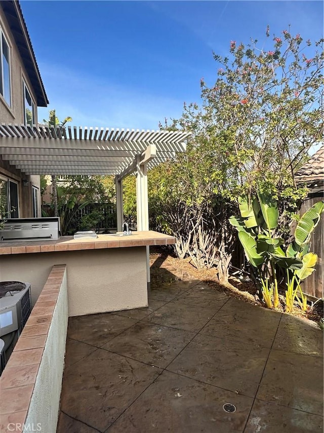 view of patio with a bar and a pergola