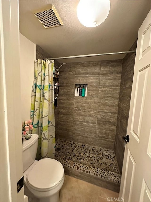 bathroom featuring toilet and walk in shower