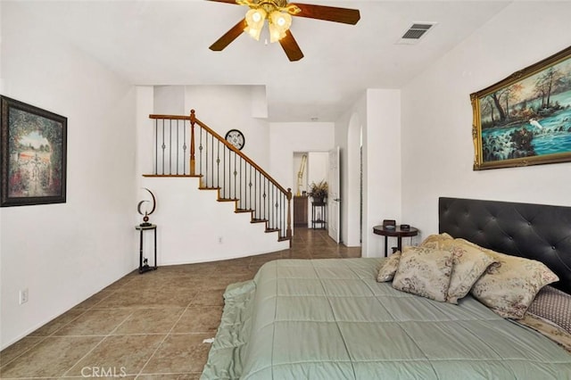 tiled bedroom featuring ceiling fan