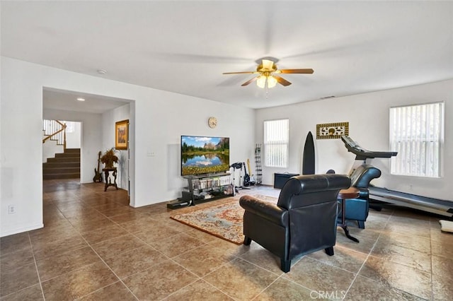 tiled living room with a baseboard radiator and ceiling fan