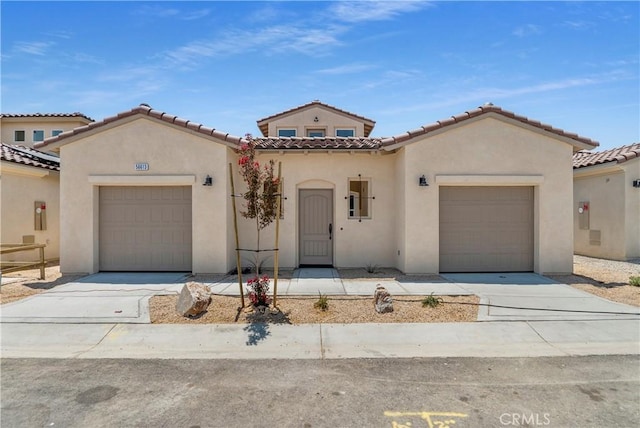 mediterranean / spanish-style home with a garage