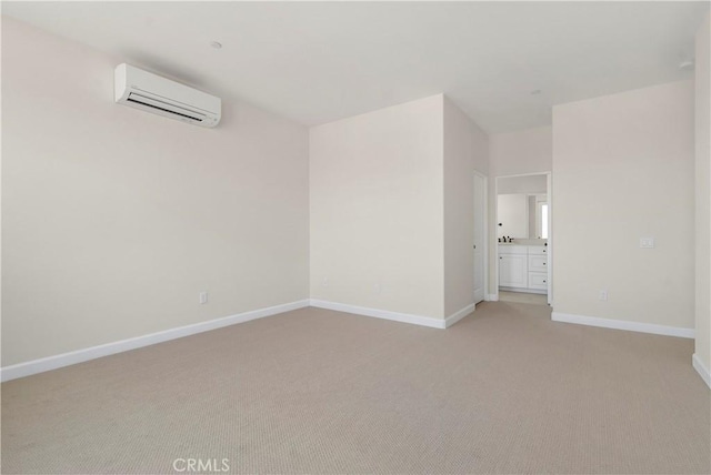 empty room with an AC wall unit and light colored carpet