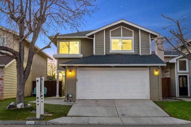 view of front of property featuring a garage and a yard