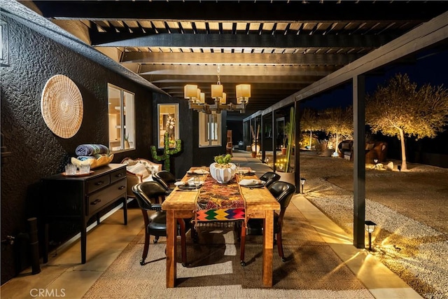 interior space featuring beamed ceiling and a notable chandelier