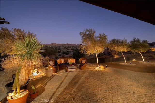 yard at dusk featuring a mountain view