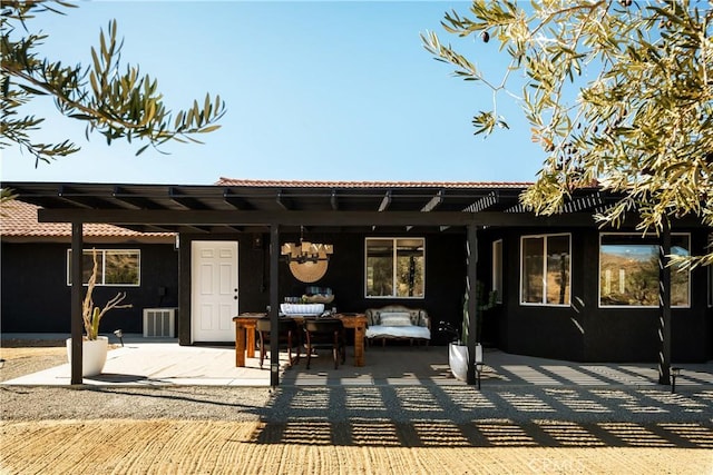 rear view of house with a pergola, a patio area, and outdoor lounge area