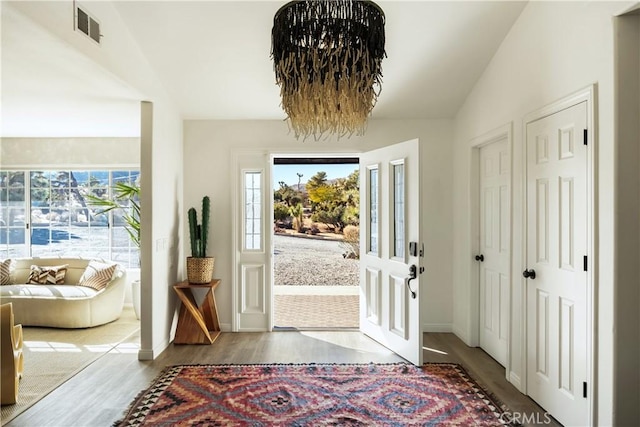 entrance foyer with vaulted ceiling and light hardwood / wood-style flooring