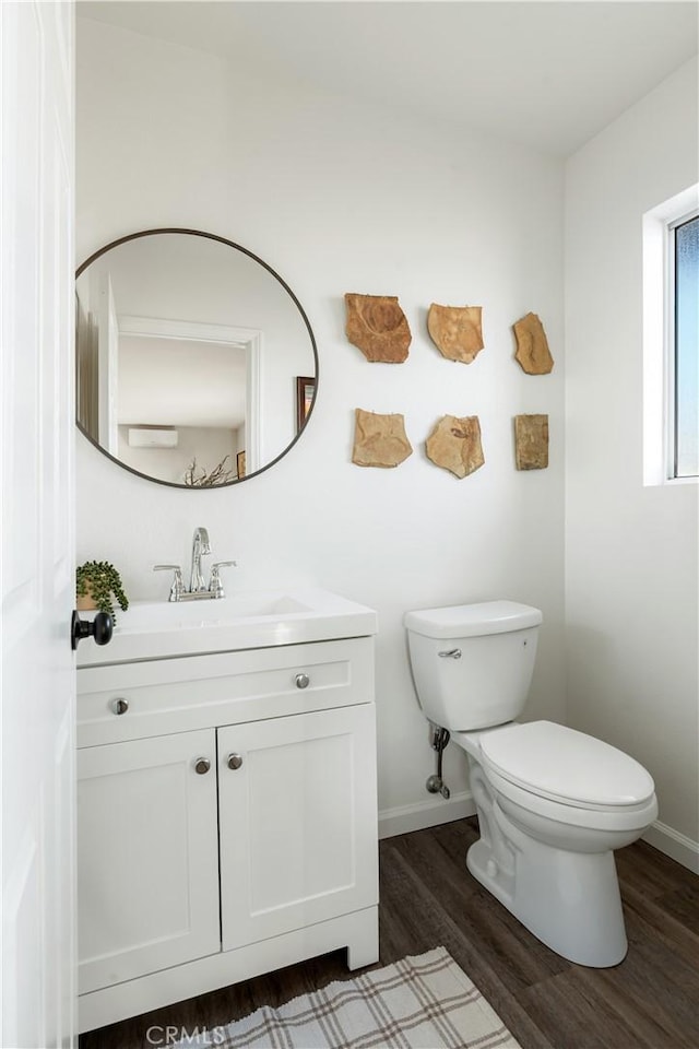 bathroom featuring vanity, toilet, and hardwood / wood-style floors