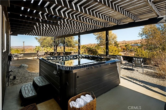 view of patio featuring a hot tub and a pergola