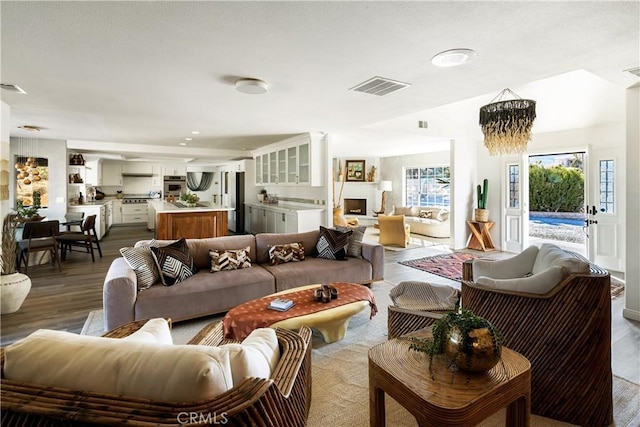 living room featuring hardwood / wood-style floors and a notable chandelier