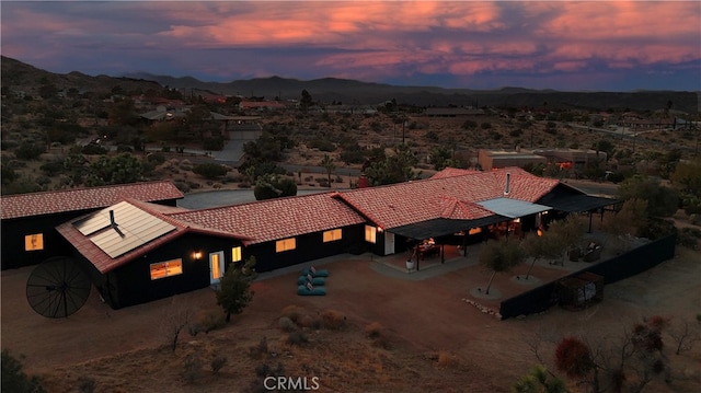 aerial view at dusk featuring a mountain view