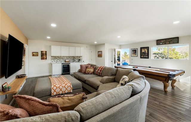 living room featuring indoor bar, billiards, beverage cooler, and light wood-type flooring