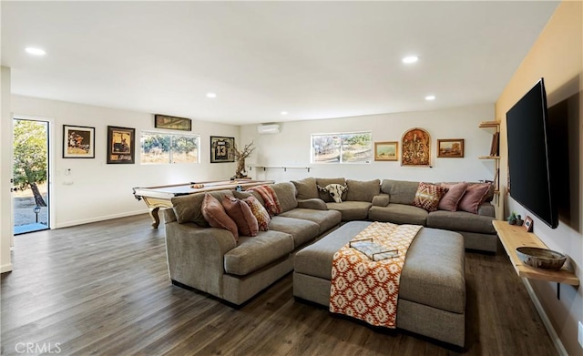 living room featuring dark wood-type flooring and a wall mounted AC