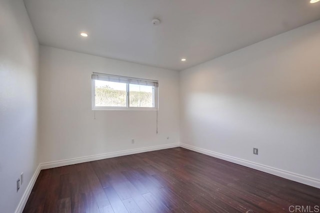 empty room with dark hardwood / wood-style floors