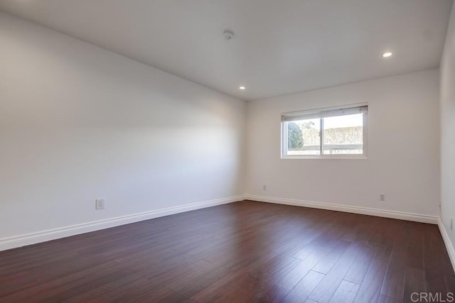 spare room featuring dark hardwood / wood-style flooring