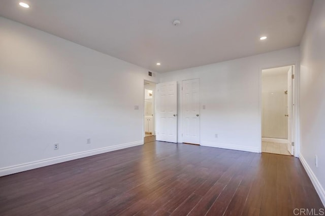 empty room with dark hardwood / wood-style flooring