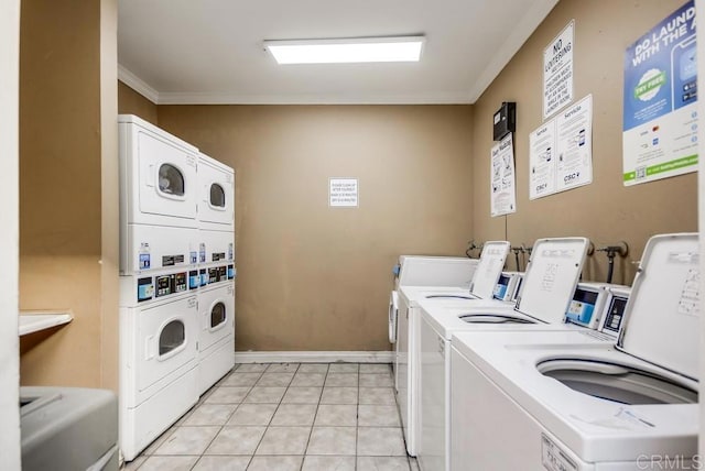 laundry area featuring washing machine and dryer, stacked washing maching and dryer, light tile patterned floors, and crown molding