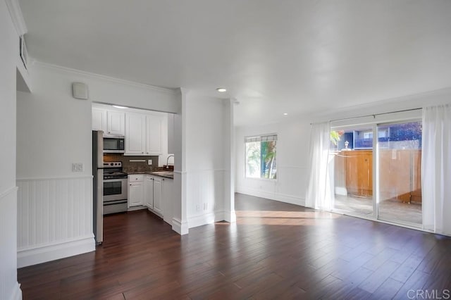 unfurnished living room with ornamental molding, dark hardwood / wood-style flooring, and sink