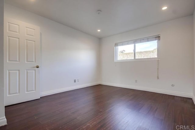 spare room with dark hardwood / wood-style floors