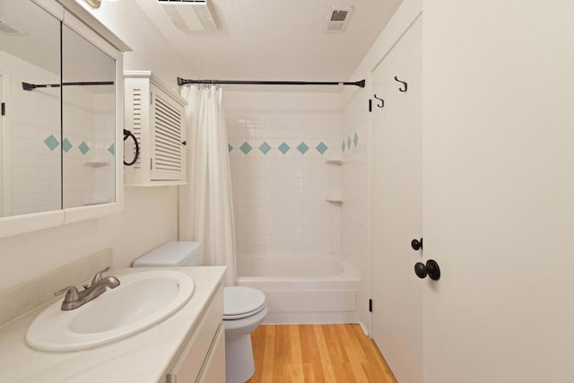 full bathroom with hardwood / wood-style flooring, shower / bath combo, vanity, and toilet