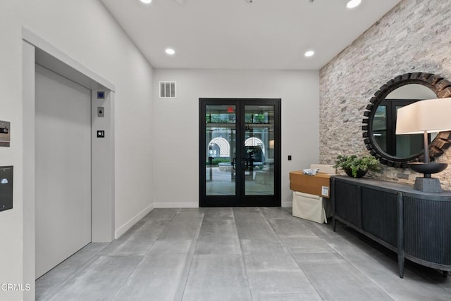 hall featuring elevator and french doors