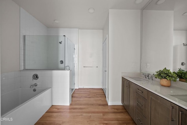 bathroom featuring vanity, hardwood / wood-style flooring, and independent shower and bath