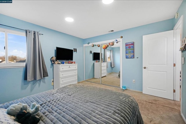 carpeted bedroom with a closet