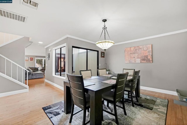 dining room featuring hardwood / wood-style floors and ornamental molding