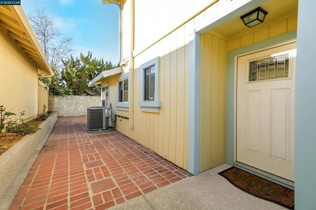 doorway to property featuring central AC unit and a patio