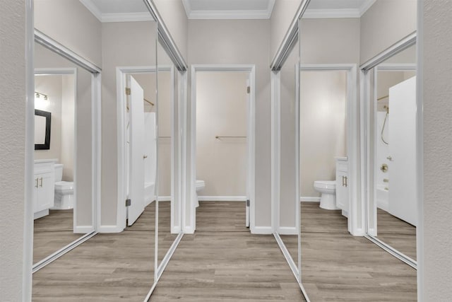 bathroom featuring hardwood / wood-style floors, ornamental molding, and toilet