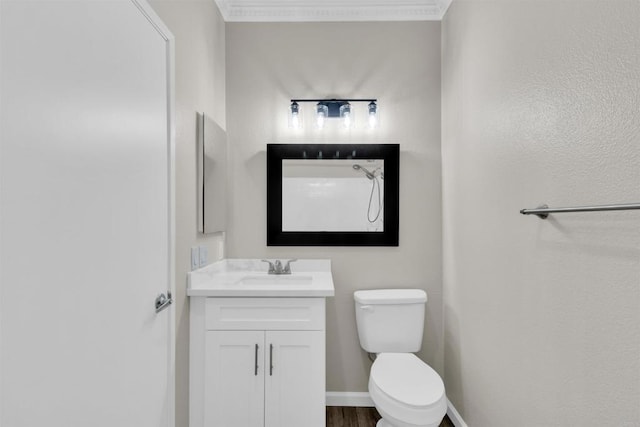 bathroom with vanity, ornamental molding, and toilet