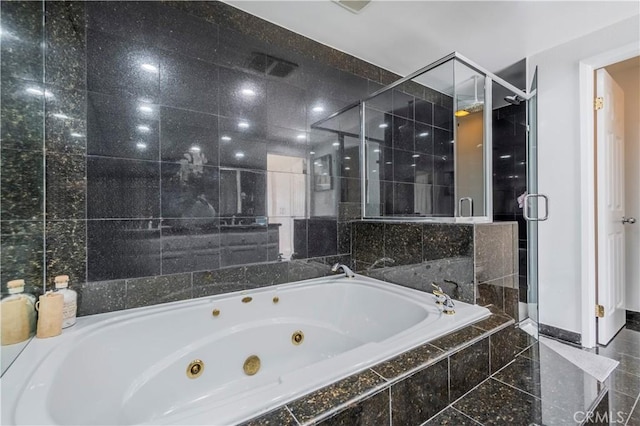 bathroom featuring plus walk in shower and tile walls