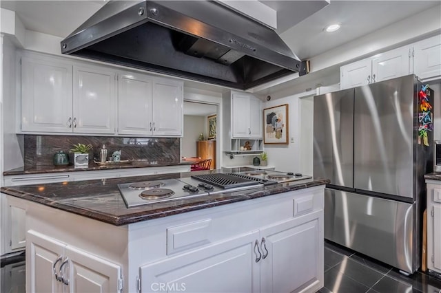 kitchen with stainless steel appliances, extractor fan, and white cabinetry