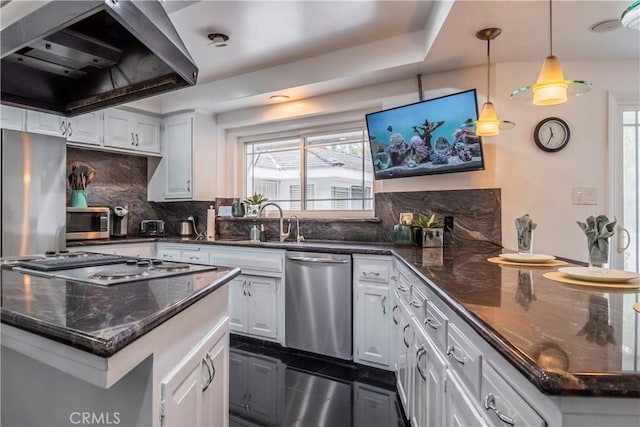 kitchen featuring white cabinetry, decorative light fixtures, appliances with stainless steel finishes, a kitchen island, and island exhaust hood