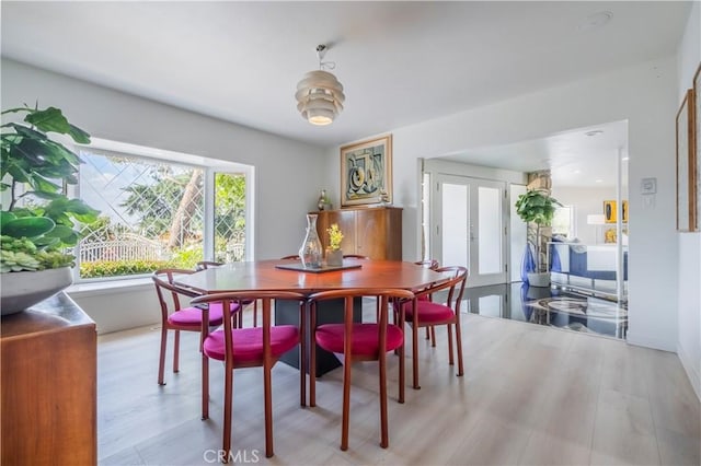 dining space featuring light hardwood / wood-style flooring and french doors