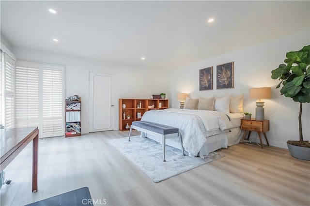 bedroom featuring access to outside and light hardwood / wood-style flooring