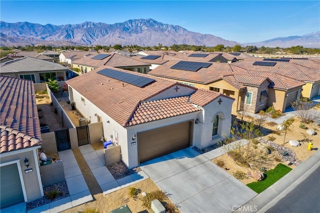 48 Vintage, Rancho Mirage, CA 92270 - view of front facade featuring a tiled roof, stucco siding, a gate, a residential view, and an attached garage