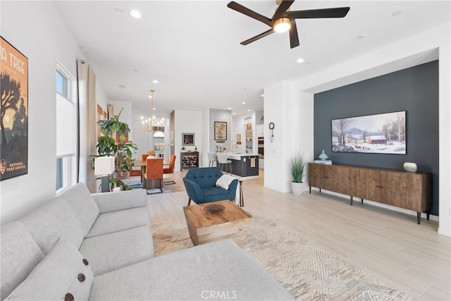 living room featuring ceiling fan and light hardwood / wood-style flooring