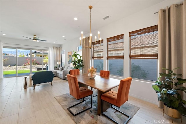 dining room with ceiling fan with notable chandelier