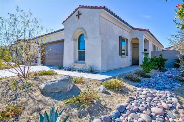 mediterranean / spanish-style house with a garage