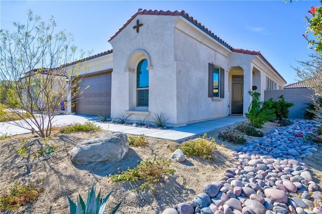 48 Vintage, Rancho Mirage, CA 92270 - view of front of house featuring a tile roof, stucco siding, and an attached garage