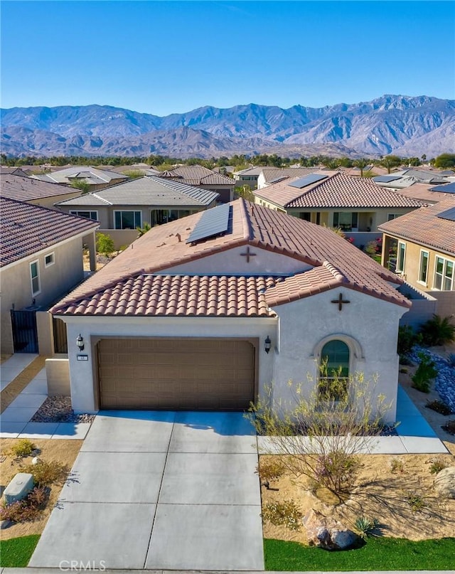 48 Vintage, Rancho Mirage, CA 92270 - mediterranean / spanish home with concrete driveway, solar panels, a tile roof, a mountain view, and stucco siding
