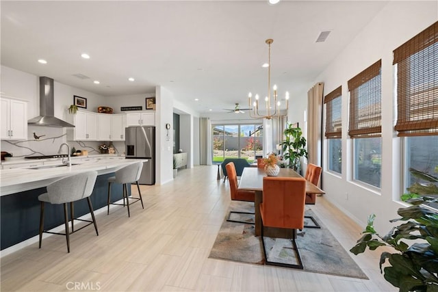 dining space featuring a notable chandelier and sink