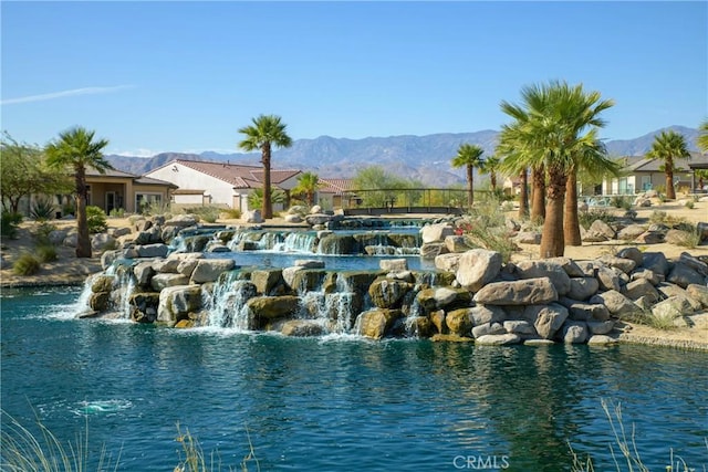 view of swimming pool featuring a water and mountain view